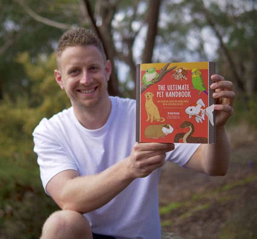Wildlife advocate Ben Dessen holds his book as he writes about reptiles as pets and other unusual pets ahead of the Pet Show in Brisbane